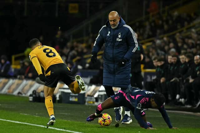 Nottingham Forest manager Nuno Espirito Santo (C) looks on as Wolves midfielder Joao Gomes (L) and Forest's Anthony Elanga (R) fight for the ball (Photo by BEN STANSALL/AFP via Getty Images)
