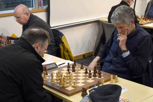 A study in concentration as players ponder their next move.