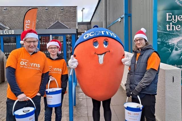 Volunteers as one of Acorn's bucket collectors as you support their important mission