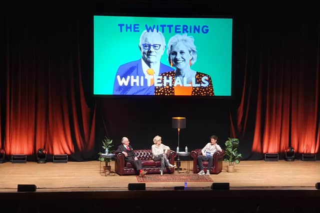 Hilary and Michael Whitehall took the stage with an image of their popular podcast