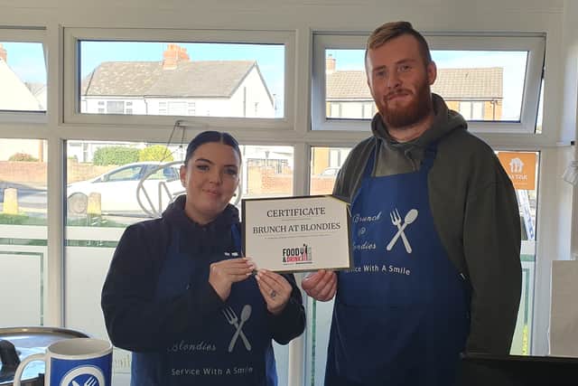 Kimberley Shaw and Adam Slater show off the certificate for being named a readers favourite