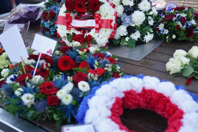 Wreaths are laid during a memorial service at 1000 Trades Square, outside New Street station in Birmingham to mark the 50th anniversary of Birmingham pub bombings (PA)