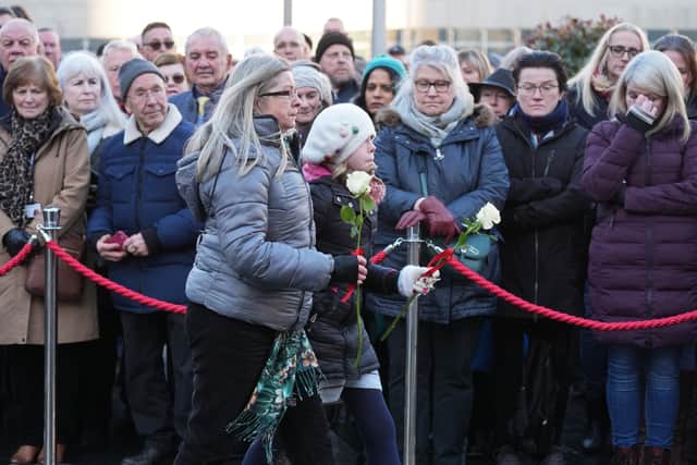 Members of the public lay flowers to mark the 50th anniversary of Birmingham pub bombings