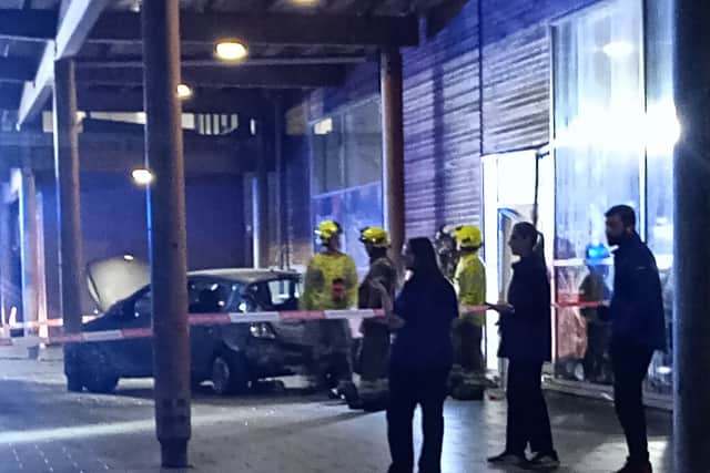 Emergency servies could seen working at the scene of a crash where a car collided with a Tesco building