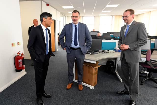 Editor Mark Drew, centre, with Rishi Sunak and senior news correspondent Mark Andrews in the newsroom