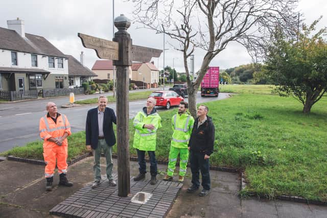 Taking a look at the newly restored post are, from left, Phil Cheshire of Colas, Geoff Egginton, National Highways’ Route Manager David East and Environment Team Manager Sam Newbold, and restorer John Gutsell