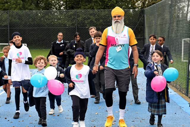 Amrit Singh Sehra is flanked by Manny Singh Kang as he completes his 5,000 step challenge