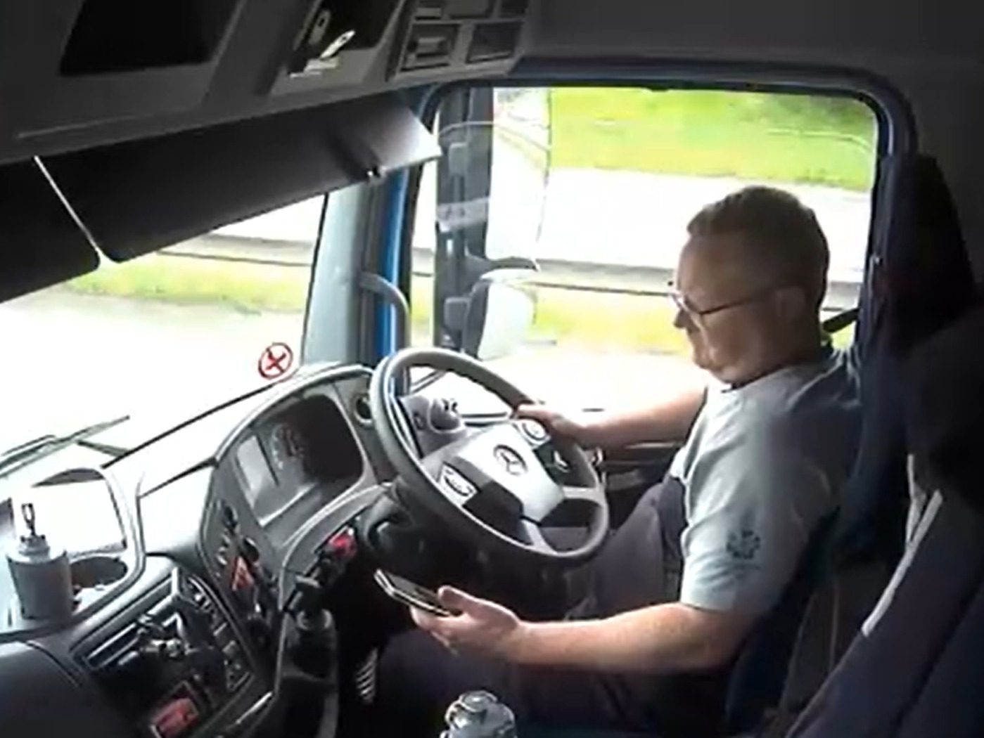 Watch: Lorry driver distracted by phone crashes into broken-down car ...