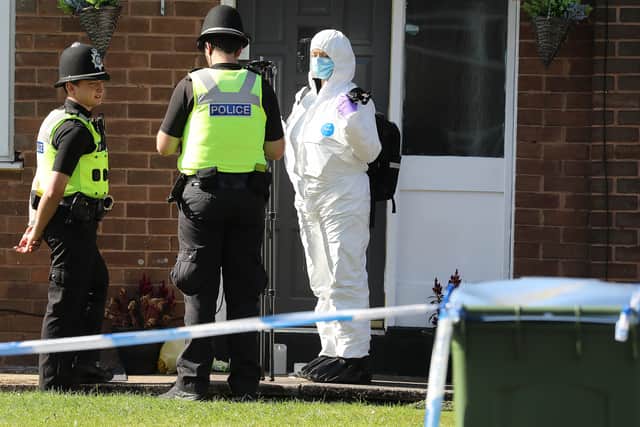 Police at the scene the day after the fatal stabbing