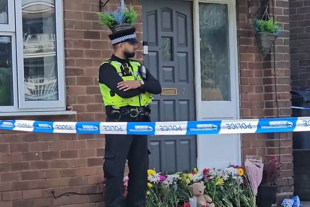 Floral tributes have been left outside the house in Lovett Avenue where the 13-year-old boy was stabbed to death
