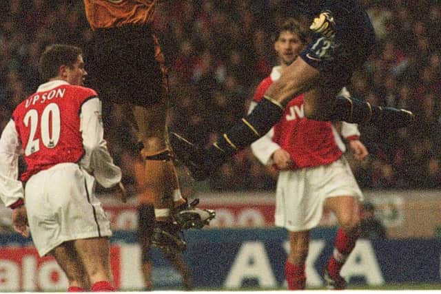 Wolves Havard Flo (No.9) beats Arsenal goalkeeper Alex Manninger to equalise
