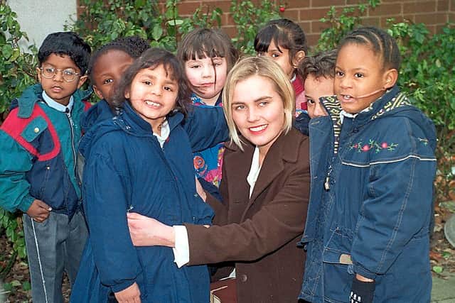 Lisa Potts with some of her pupils at St Luke's School with Reena Chopra and Francesca Quintyne-Peart after the 1996 attack.