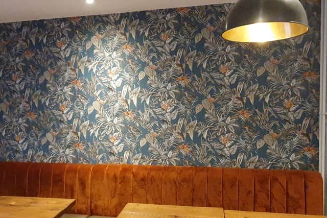 The wallpaper is flowery and colourful