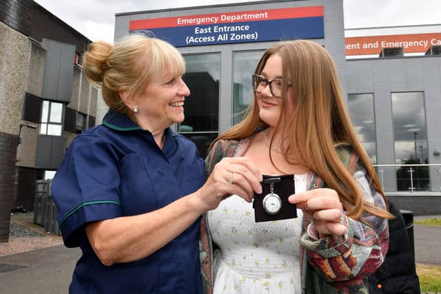 Janine McKnight passes her watch on to her hard-working niece, Tegan Wood, who will soon follow in her auntie's footsteps.