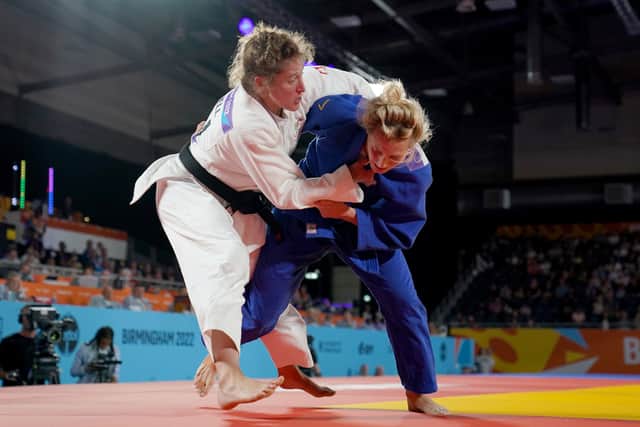               England   s Emma Reid (blue) 