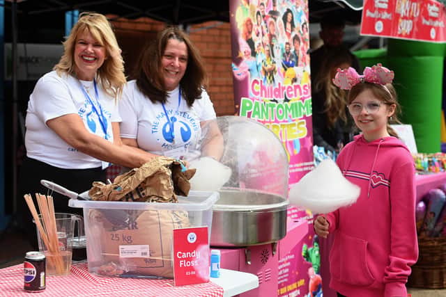 The Black Country Duck Race at Brierley Hill Waterfront. Macy Leddington 10 gets Candy Floss from Susan Totney and Jill Dixon