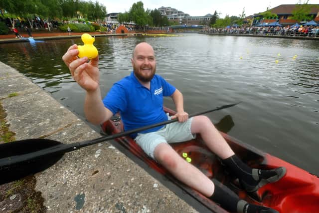The Black Country Duck Race at Brierley Hill Waterfront. With the winning duck is boat man James Alma