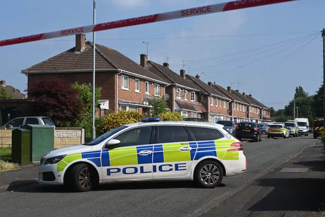 Police at the scene of the house fire in  Placomb Road Wolverhampton on June 25
