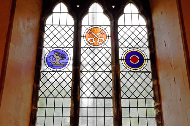 The window has symbols to represent the rail disaster, St Peter's school and parish and RAF Hixon
