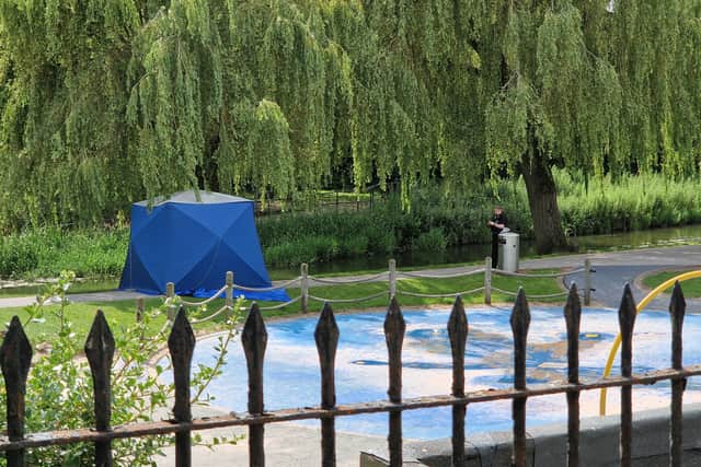 A tent was seen between the river and the children's play area