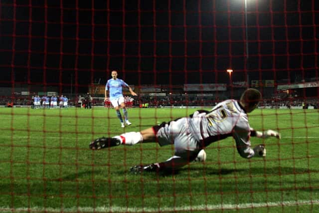 Doncaster Rovers' goal keeper Jan Budtz (R) saves kick from Manchester City's Antoine Sibierski during penalty shoot-out in the Carling Cup second round match