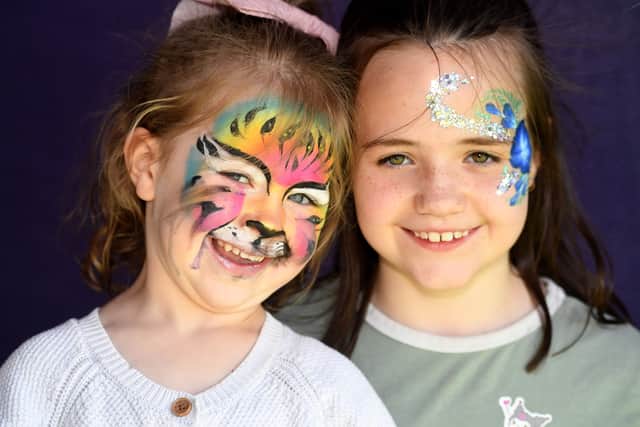 Dana McIvor, aged four and sister Anabelle, aged nine, all smiles with painted faces.