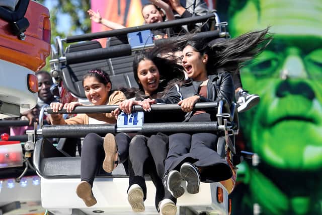 Visitors enjoying the fun fair rides.