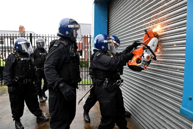 Police cutting their way into the factory