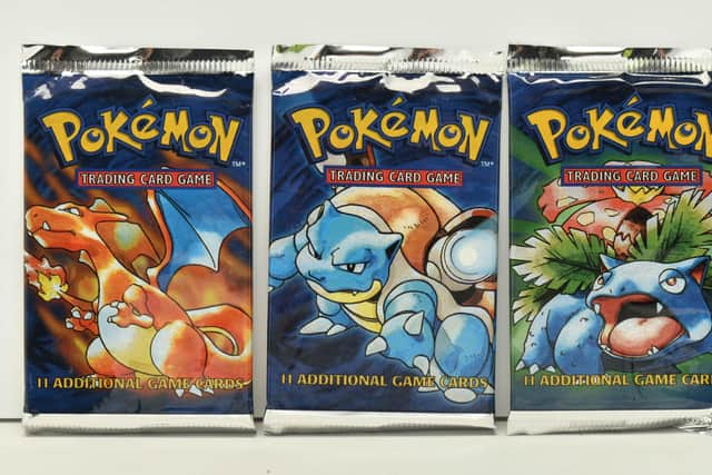 Lot 462A is this Pokémon Base Set booster pack art set, with three sealed packs featuring the Charizard, Blastoise and Venusaur designs.