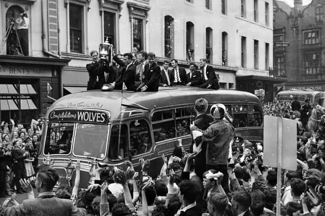 The cup is held aloft on the team coach, which was supplied by Don Everall.