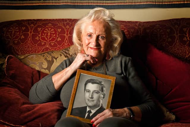 Patricia Wright holds a photograph of her late husband Alan, who arrested the Kray twins
