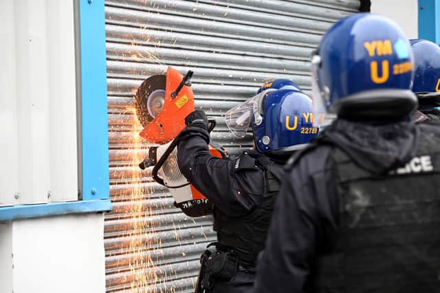 Police forcing their way in