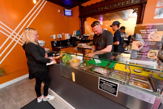 Phill Bennett works to provide a customer with their order