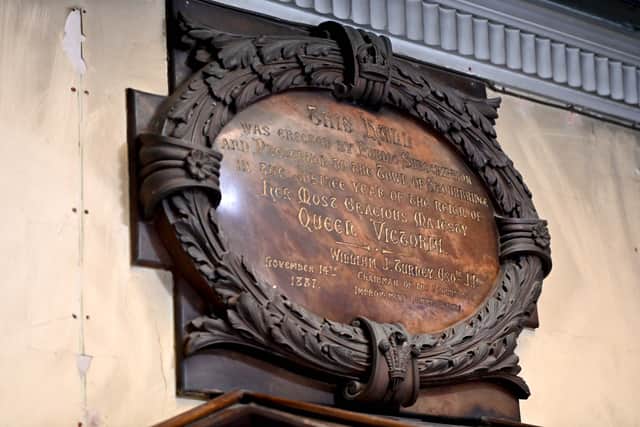 A plaque on the wall tells how the hall was built in honour of Queen Victoria on her Jubilee