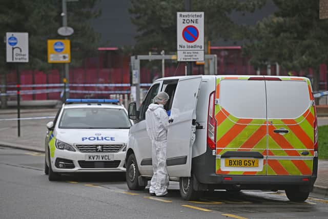A forensic investigator at the scene where a 15-year-old boy was fatally stabbed