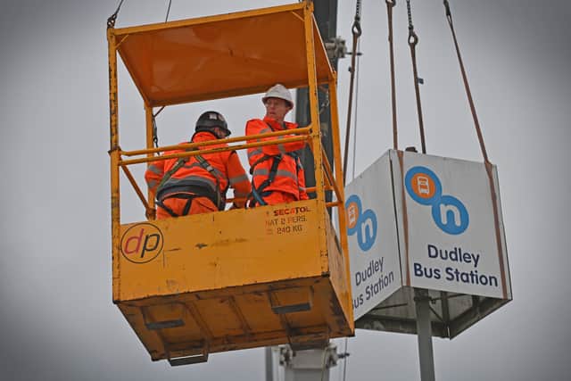 Andy Street helps to remove the Dudley bus station sign