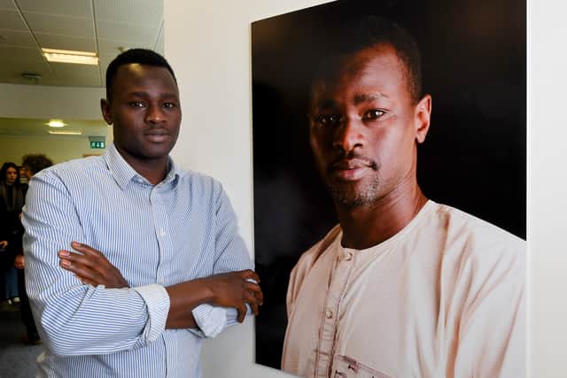 An exhibition by Dudley College students on the subject of refugees is on display at The Archives building, Dudley Mansoor Suliman, next to the photograph of himself..