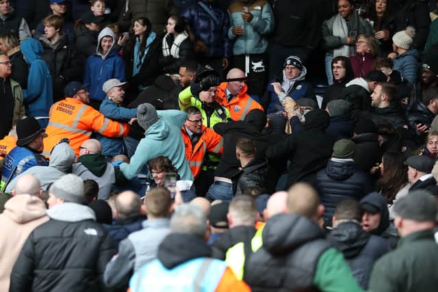 Trouble erupts in the stadium as a Wolverhampton Wanderers fan celebrates their second goal amongst Albion fans as a steward and Police attempt to protect him, forcing a 36 minute game stoppage (Photo by Adam Fradgley/West Bromwich Albion FC via Getty Images).
