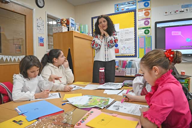Laura Elena Suna teaches some of the Romanian youngsters about their culture