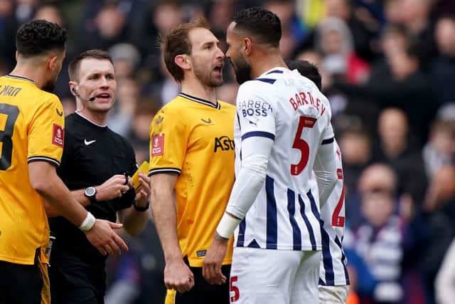 Wolverhampton Wanderers' Craig Dawson (left) and West Bromwich Albion's Kyle Bartley clash