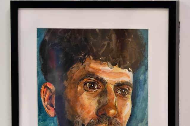 DUDLEY COPYRIGHT NATIONAL WORLD PLC TIM THURSFIELD 07/02/24.An exhibition by Dudley College students on the subject of refugees is on display at The Archives building, Dudley..A painting by organiser Chris Davies on display..