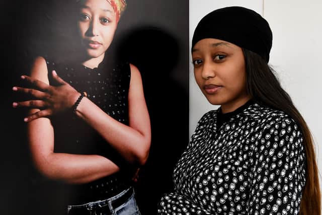 An exhibition by Dudley College students on the subject of refugees is on display at The Archives building, Dudley..Dian Diallo is shown next to her portrait..