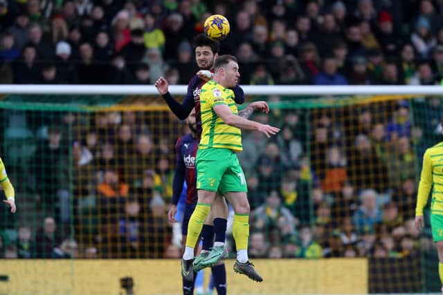 Okay Yokuslu challenges with Norwich forward Ashley Barnes (Photo by Adam Fradgley/West Bromwich Albion FC via Getty Images).