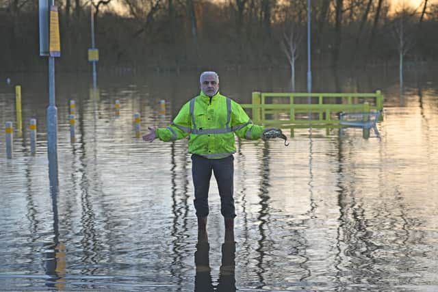 Local developer George Chrisostomou stands in the flood water