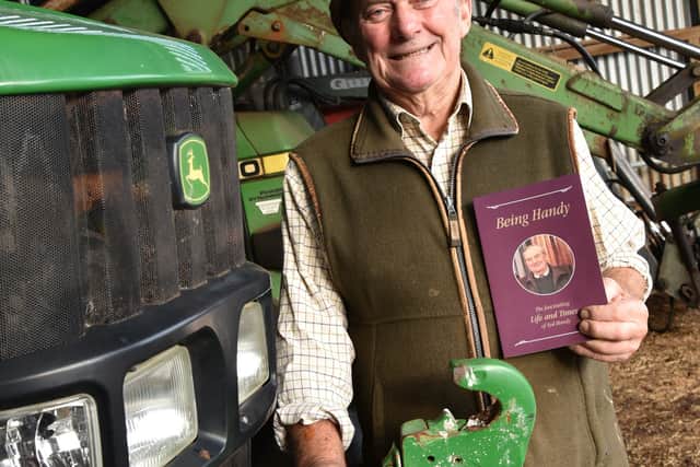 Syd Handy with his book