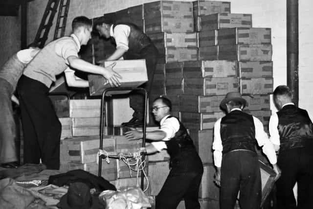 Stacking the masks in the warehouse in Raglan Street before assembly.