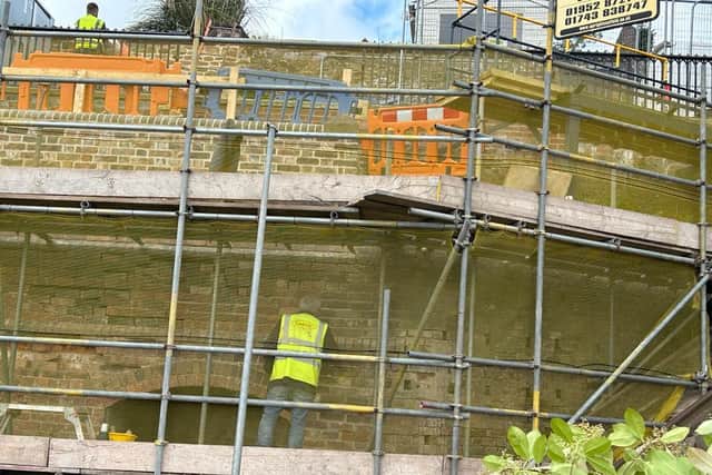 Workman repairing the Cliff Railway wall