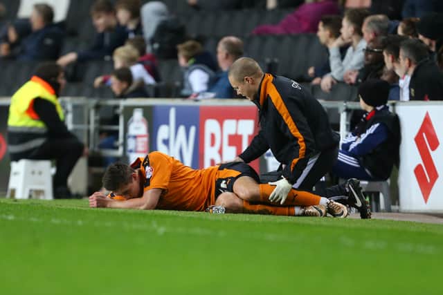 An injured Michal Zyro of Wolverhampton Wanderers .