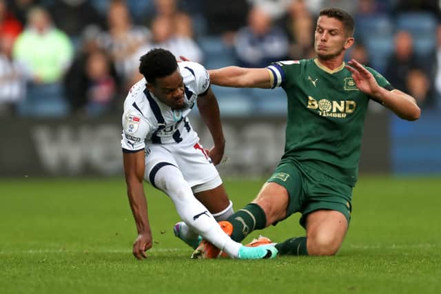 WEST BROMWICH, ENGLAND - OCTOBER 21: Jordan Houghton goes over the top on Grady Diangana (Photo by Adam Fradgley/West Bromwich Albion FC via Getty Images).