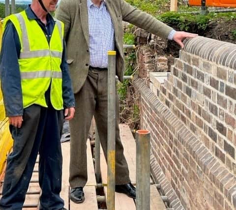 Railway owner Dr Malvern Tipping with cliff railway engineer Barry Evans inspecting the repaired retaining wall 
